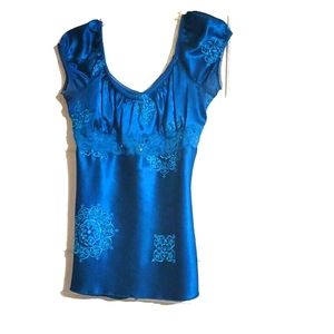 Heartsoul babydoll top with flower pattern and string tie in back.